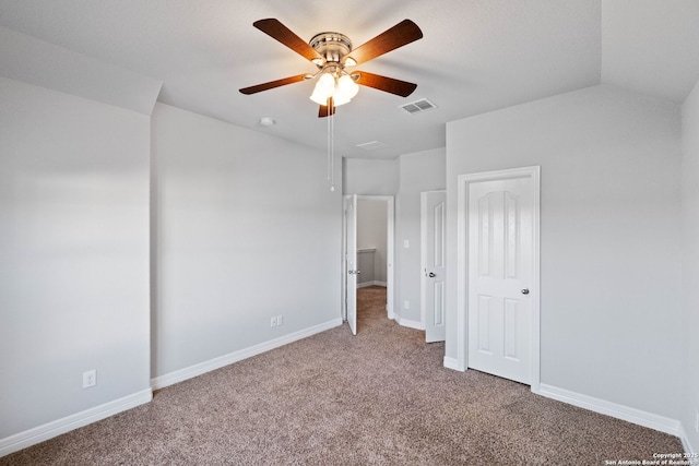 unfurnished bedroom featuring carpet floors, vaulted ceiling, and ceiling fan