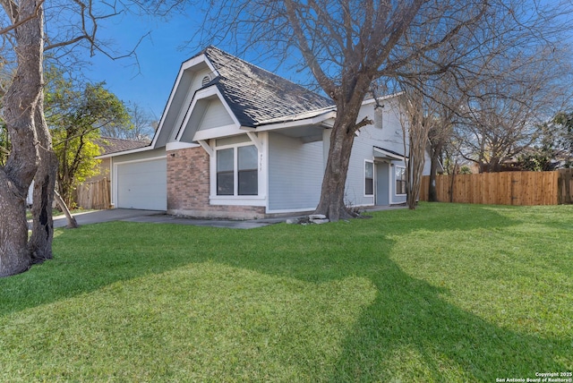 view of front of property with a front lawn and a garage