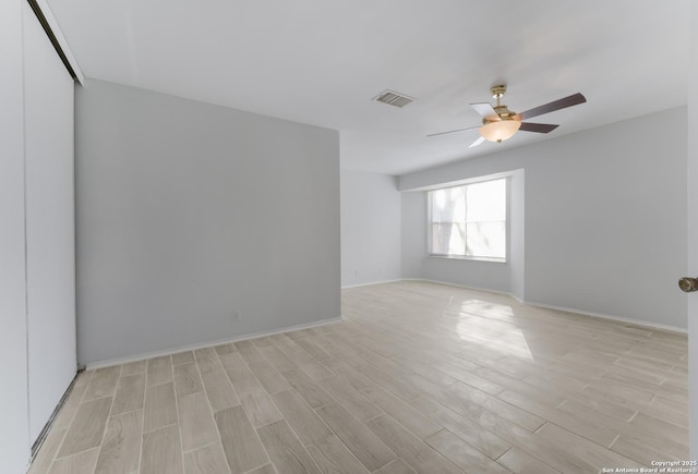 unfurnished room featuring light hardwood / wood-style floors and ceiling fan