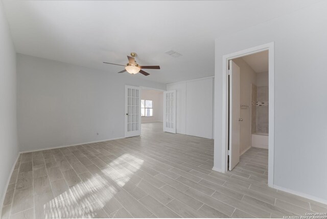 spare room featuring french doors and ceiling fan