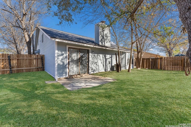 rear view of house with a yard and a patio area