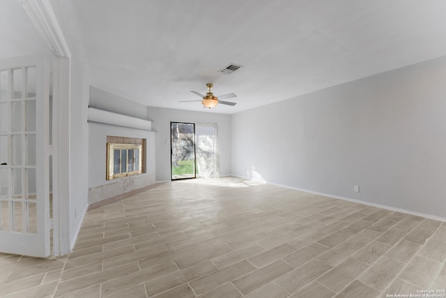 unfurnished living room with ceiling fan, light hardwood / wood-style flooring, and a tiled fireplace