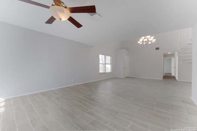 unfurnished living room with ceiling fan with notable chandelier