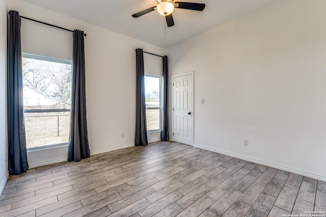 unfurnished room featuring ceiling fan and a healthy amount of sunlight