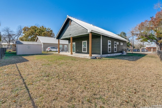 rear view of property with a lawn and a patio