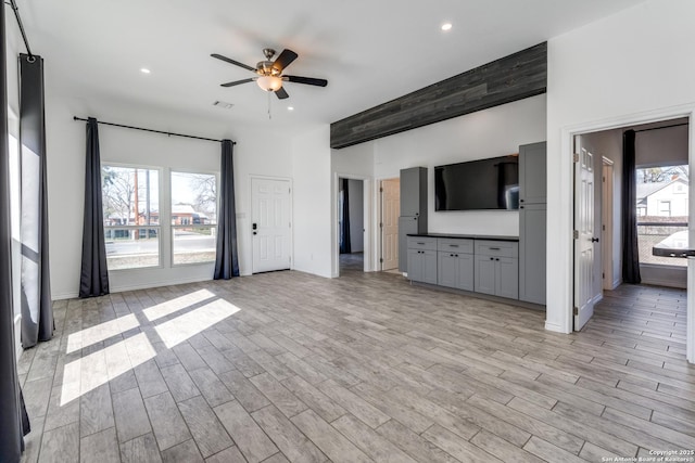 unfurnished living room featuring ceiling fan