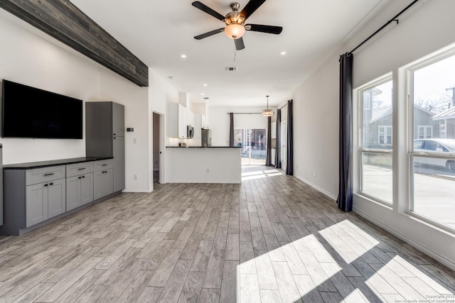 unfurnished living room featuring ceiling fan