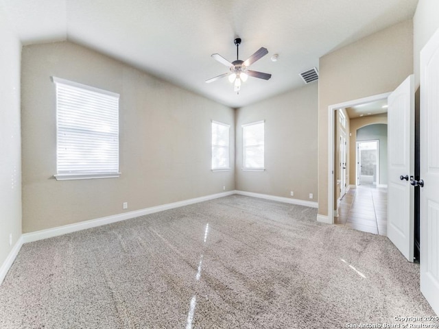 unfurnished room with ceiling fan, light colored carpet, and vaulted ceiling