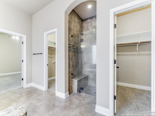 bathroom featuring tile patterned floors and a shower with door