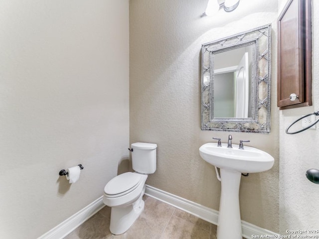 bathroom featuring tile patterned floors and toilet