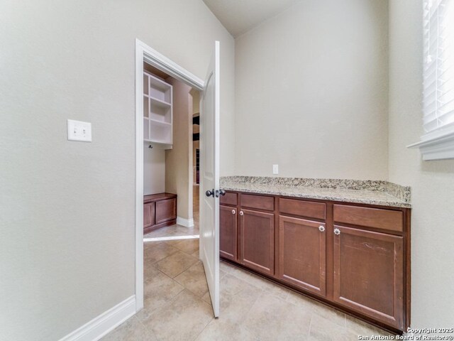 bathroom with tile patterned flooring and vaulted ceiling