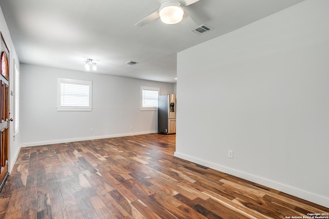 empty room featuring ceiling fan and dark wood-type flooring