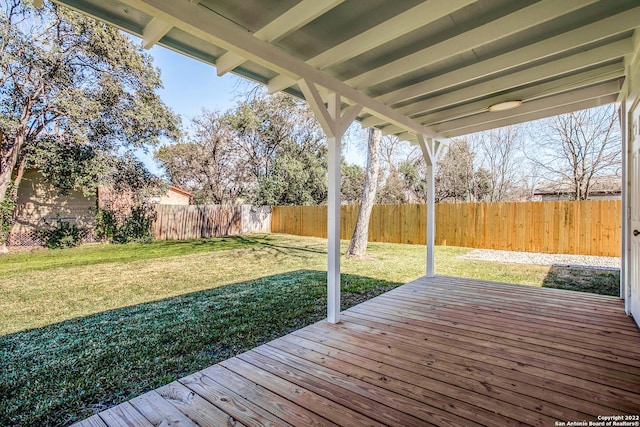 wooden deck featuring a lawn