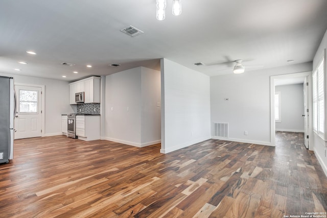 unfurnished living room featuring hardwood / wood-style floors and ceiling fan