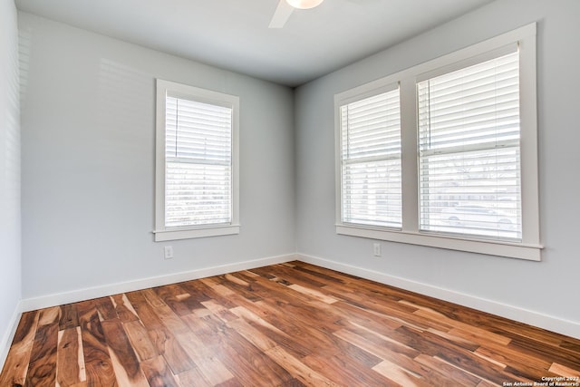 empty room with hardwood / wood-style floors and ceiling fan