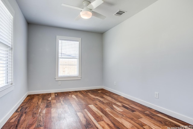 spare room featuring dark hardwood / wood-style flooring and ceiling fan