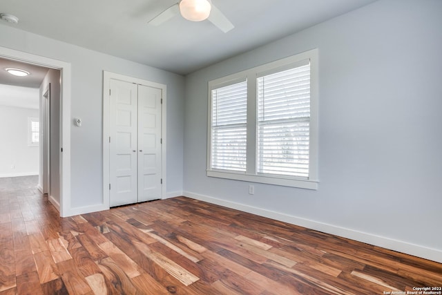 unfurnished bedroom with a closet, ceiling fan, and hardwood / wood-style floors