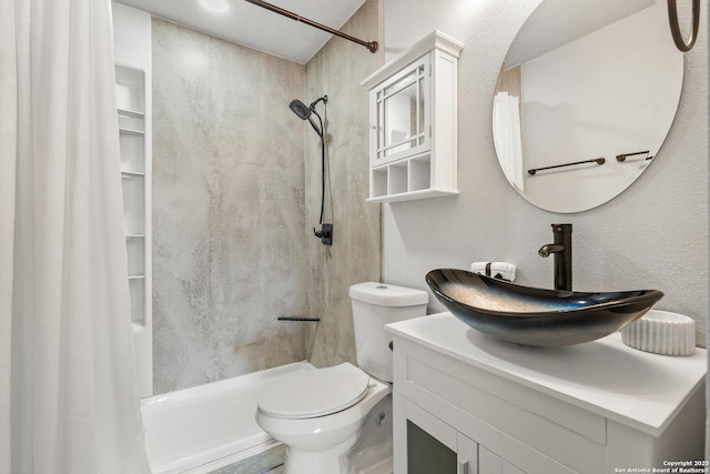 bathroom featuring curtained shower, vanity, and toilet