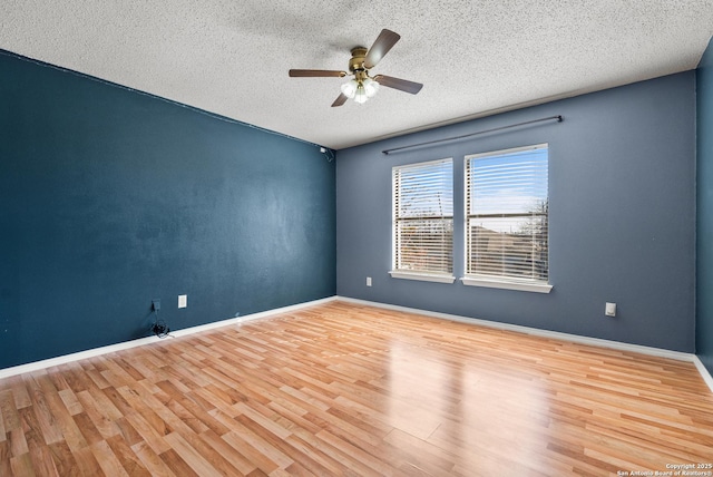 unfurnished room featuring ceiling fan, light hardwood / wood-style floors, and a textured ceiling