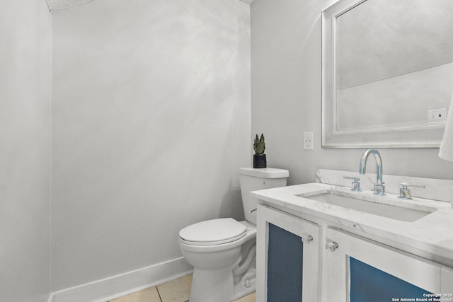 bathroom featuring tile patterned floors, vanity, and toilet