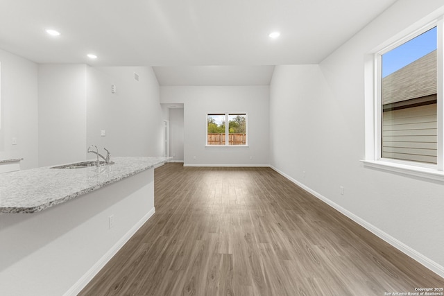 unfurnished living room featuring dark hardwood / wood-style flooring and sink