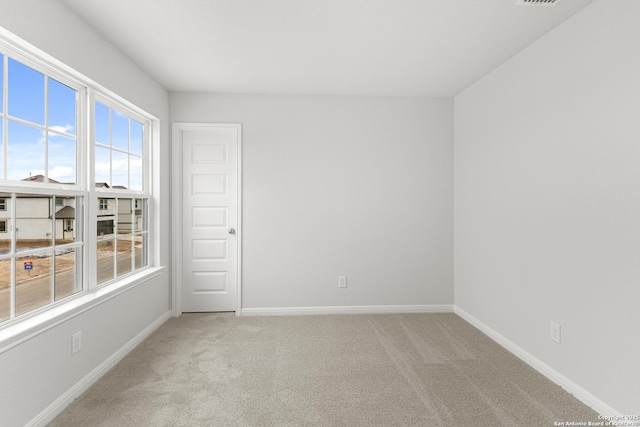 spare room featuring light colored carpet