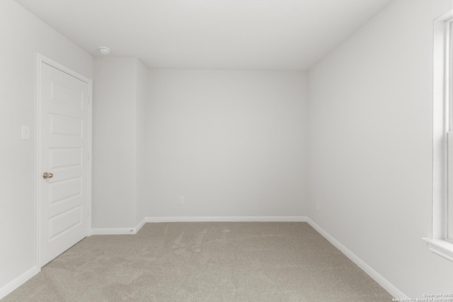 spare room featuring light colored carpet