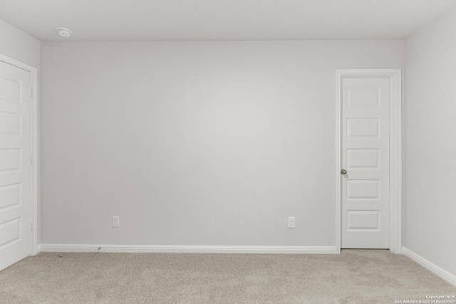 unfurnished room featuring light colored carpet