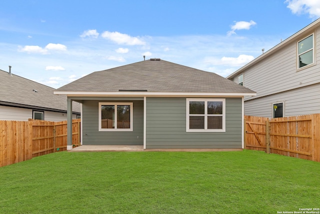 back of house featuring a yard and a patio