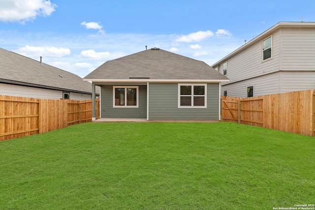 rear view of property with a lawn