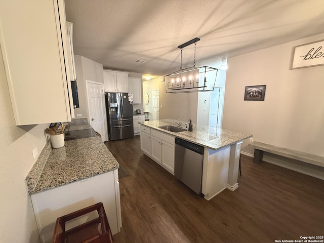 kitchen with white cabinetry, sink, an island with sink, and appliances with stainless steel finishes