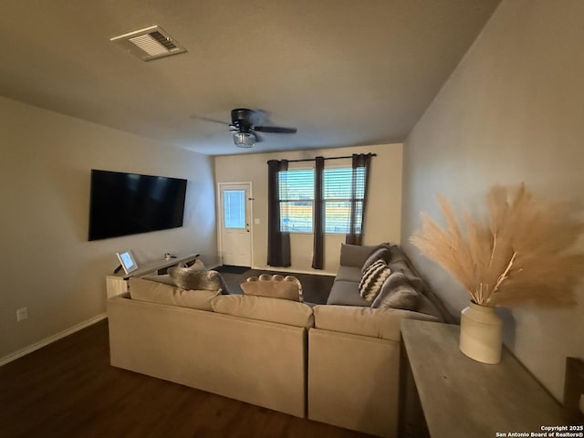 home theater room with dark hardwood / wood-style flooring and ceiling fan