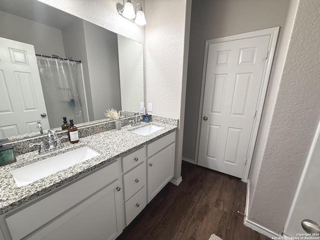 bathroom featuring a shower with curtain, hardwood / wood-style floors, and vanity