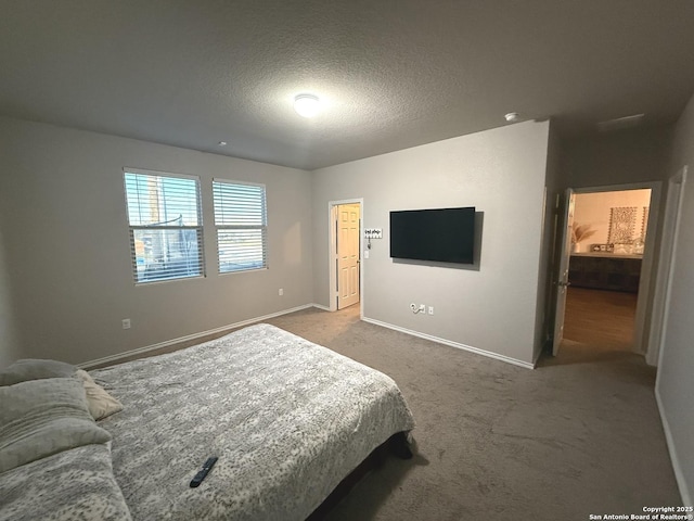 carpeted bedroom featuring a textured ceiling