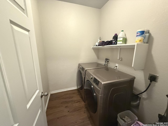 laundry area with dark hardwood / wood-style floors and washing machine and dryer