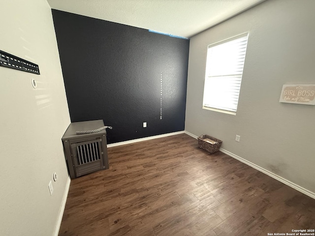 spare room with dark hardwood / wood-style floors