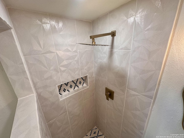 bathroom with a tile shower