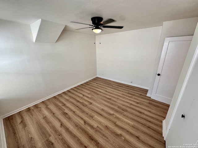 additional living space featuring wood-type flooring and ceiling fan