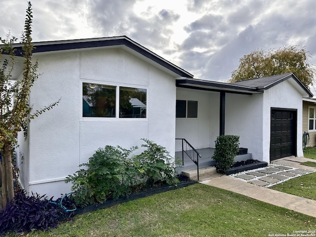 view of front of house with a garage and a front lawn