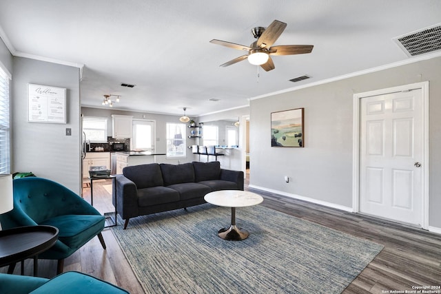 living room featuring ceiling fan, dark hardwood / wood-style flooring, and crown molding