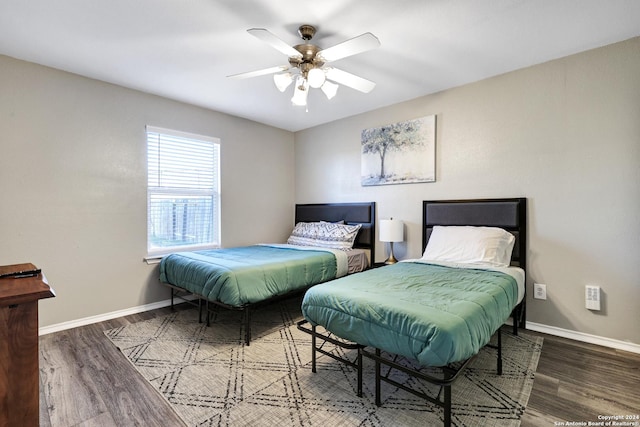 bedroom featuring dark hardwood / wood-style flooring and ceiling fan