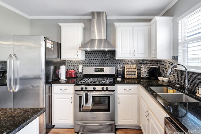 kitchen featuring white cabinetry, sink, stainless steel appliances, and wall chimney range hood