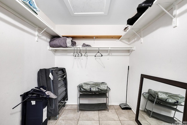 walk in closet with light tile patterned floors