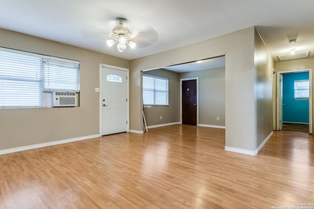 foyer with light wood-type flooring, ceiling fan, and cooling unit