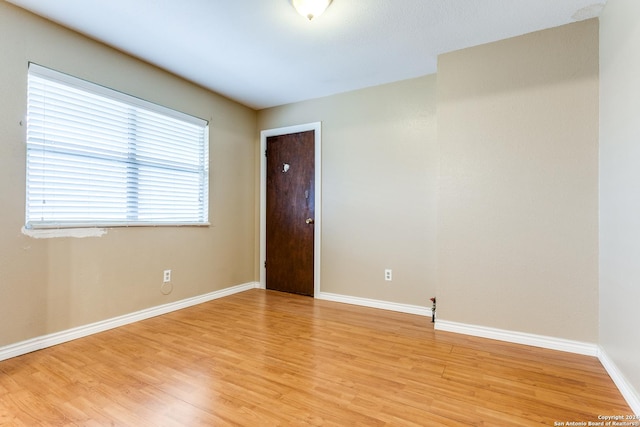 spare room with light hardwood / wood-style flooring