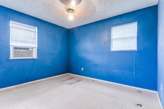 empty room featuring ceiling fan and cooling unit