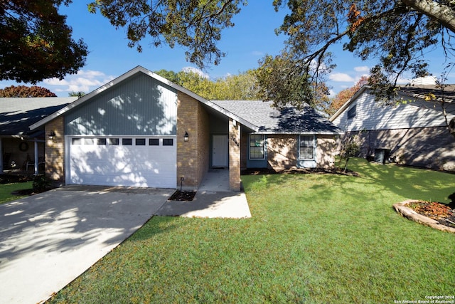 view of front of home with a garage and a front lawn