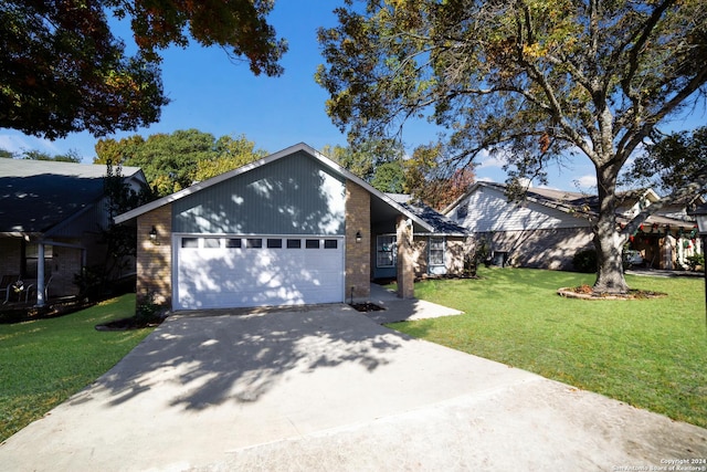 view of front of house with a front yard and a garage