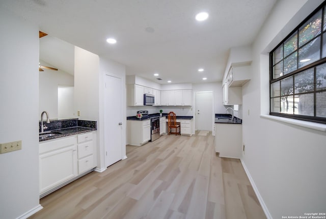 kitchen featuring white cabinets, light hardwood / wood-style floors, sink, and stainless steel appliances