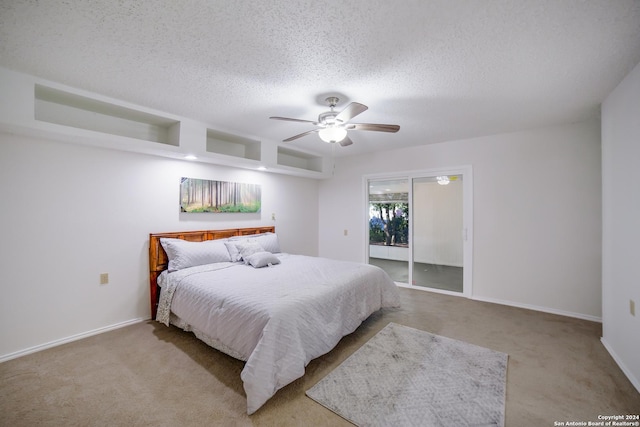 carpeted bedroom with ceiling fan and a textured ceiling